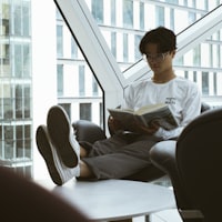 Jordan Lee headshot smiling in office with laptop